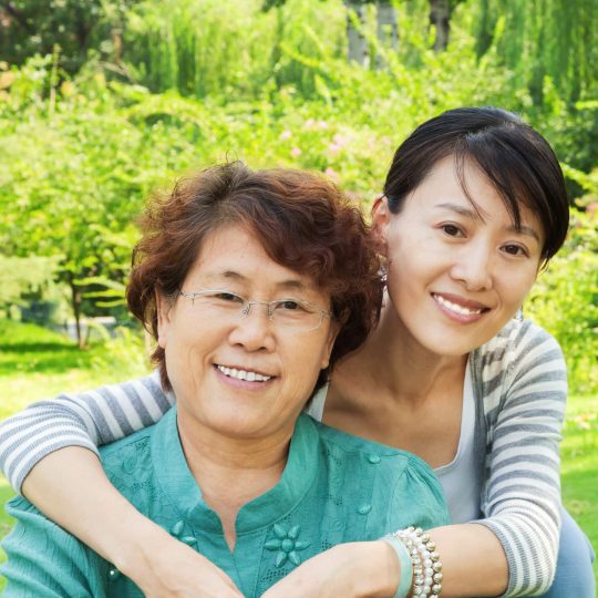 Two Generation:Asian mother and daughter on grass